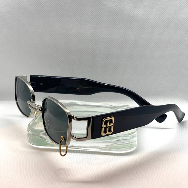Retro, vintage style sunglasses with black tinted lenses and a silver frame.